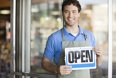 Man holding a Open sign